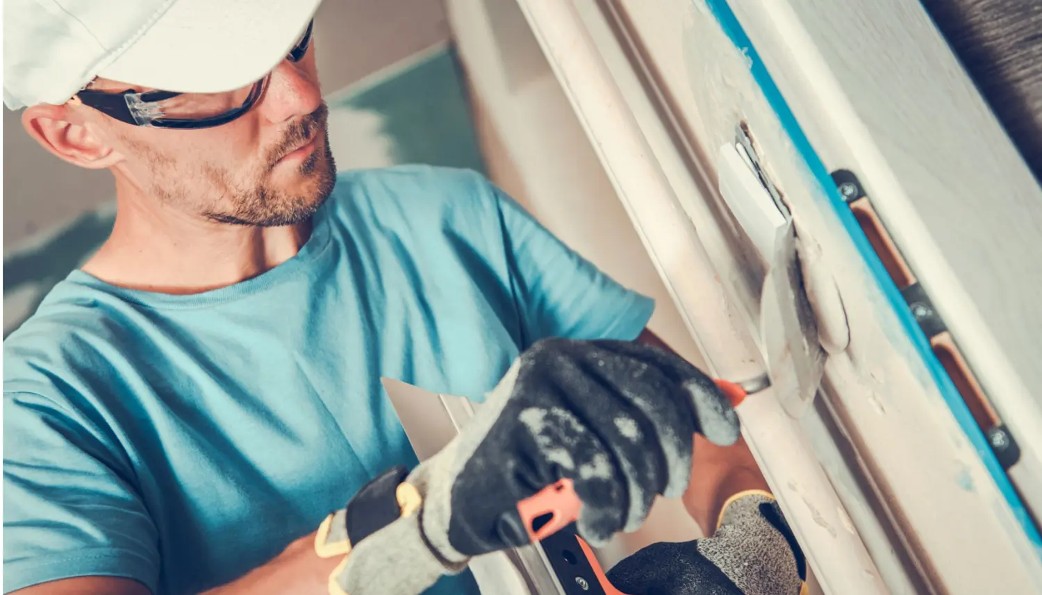 Home drywall repair in Savannah, GA, showing a technician carefully fixing wall imperfections.